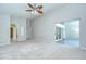 Bright bedroom with ceiling fan, light carpet, and sliding glass doors to the patio at 15126 Shearcrest Dr, Lithia, FL 33547