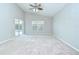 Spacious bedroom with vaulted ceiling, large window, and sliding glass door to the pool area at 15126 Shearcrest Dr, Lithia, FL 33547