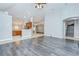 Open concept living room with wood floors, kitchen with breakfast bar, and staircase at 15126 Shearcrest Dr, Lithia, FL 33547