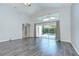 Bright, airy living room featuring wood floors and sliding glass doors leading to a pool area at 15126 Shearcrest Dr, Lithia, FL 33547