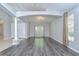 Spacious living room with hardwood flooring, modern fixtures, neutral walls, and lots of natural light at 15126 Shearcrest Dr, Lithia, FL 33547