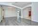 Open floor plan featuring hardwood floors, neutral walls, elegant lighting fixtures, and access to kitchen at 15126 Shearcrest Dr, Lithia, FL 33547