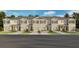 New townhome exteriors showcase neutral color schemes and coordinated window shutters at 2472 Riversong Lodge Ln, Wesley Chapel, FL 33543