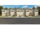 Charming townhome showcasing a well-manicured lawn and a neutral color palette at 2480 Riversong Lodge Ln, Wesley Chapel, FL 33543