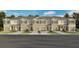 Charming townhome showcasing a well-manicured lawn and a neutral color palette at 2480 Riversong Lodge Ln, Wesley Chapel, FL 33543
