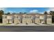 Exterior view of townhomes with garages, shutters, and landscaping under a blue sky at 2486 Riversong Lodge Ln, Wesley Chapel, FL 33543