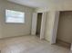 Bedroom featuring tiled floors, a window and closets with bifold doors at 2501 Harn Blvd # H20, Clearwater, FL 33764