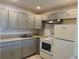 Kitchen featuring neutral cabinets and white appliances at 2501 Harn Blvd # H20, Clearwater, FL 33764