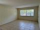 Bright living room with a window offering natural light, and neutral tile flooring throughout at 2501 Harn Blvd # H20, Clearwater, FL 33764
