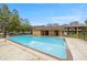 Inviting community pool surrounded by a secure fence and lush greenery, perfect for relaxation and recreation at 2501 Harn Blvd # H20, Clearwater, FL 33764