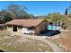 View of community pool house, mailboxes, and pool surrounded by a secure fence, and greenery at 2501 Harn Blvd # H20, Clearwater, FL 33764