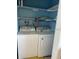 Laundry room with a washer and dryer, plus shelving for storage at 2617 Cove Cay Dr # 306, Clearwater, FL 33760