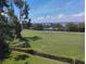 Scenic view of a green field with trees and a body of water in the distance at 2617 Cove Cay Dr # 306, Clearwater, FL 33760