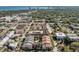Overhead shot of residences with pool, lush trees, nearby bay, and city skyline in the distance at 501 S Moody Ave # 1134, Tampa, FL 33609