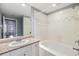 Bathroom featuring granite vanity, shower and bathtub with tiled wall and shower door at 501 S Moody Ave # 1134, Tampa, FL 33609