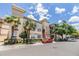 Exterior of a multi-story building featuring a beige facade with palm trees and street parking at 501 S Moody Ave # 1134, Tampa, FL 33609