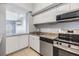Bright kitchen featuring white cabinets, granite counters, stainless steel appliances, and a breakfast bar at 501 S Moody Ave # 1134, Tampa, FL 33609