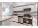 Modern kitchen with white cabinets, granite countertops, stainless steel appliances, and tile flooring at 501 S Moody Ave # 1134, Tampa, FL 33609