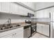 Well-equipped kitchen with white cabinets, granite counters, and stainless steel appliances, creating a clean and efficient space at 501 S Moody Ave # 1134, Tampa, FL 33609