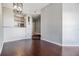 Living room area with hardwood flooring, a modern light fixture, and an open view into the adjacent kitchen at 501 S Moody Ave # 1134, Tampa, FL 33609