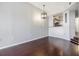 Spacious living room featuring hardwood floors and a modern light fixture, open to a kitchen area at 501 S Moody Ave # 1134, Tampa, FL 33609