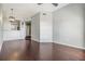Open living room with hardwood floors, neutral paint and view into the kitchen with modern light fixture at 501 S Moody Ave # 1134, Tampa, FL 33609