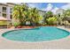 Large community pool surrounded by lush landscaping and lounge chairs at 501 S Moody Ave # 1134, Tampa, FL 33609