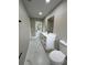 Spacious bathroom with modern vanity, double sinks, marble floors and back door leading outside at 5092 Abagail Dr, Spring Hill, FL 34608
