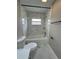 Bathroom featuring marble tiled walls and flooring, and a bathtub with a black shower head at 5092 Abagail Dr, Spring Hill, FL 34608