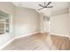 Neutral-toned bedroom features a large window, fan, and light wood flooring at 5092 Abagail Dr, Spring Hill, FL 34608