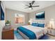 Bedroom features a cozy bed, ceiling fan, and art accent at 5092 Abagail Dr, Spring Hill, FL 34608