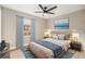 Bedroom features a window, ceiling fan, and a cozy bed with stylish decor at 5092 Abagail Dr, Spring Hill, FL 34608