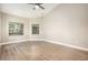 Clean bedroom showcasing a large window, ceiling fan, and neutral tones at 5092 Abagail Dr, Spring Hill, FL 34608