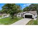Well-maintained home with a spacious driveway and a lush front yard, perfect for outdoor activities at 5092 Abagail Dr, Spring Hill, FL 34608