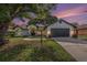 Charming single-Gathering home featuring a well-manicured lawn, mature trees, and a two-car garage at 5092 Abagail Dr, Spring Hill, FL 34608
