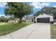 Well-maintained home with a spacious driveway and a lush front yard, perfect for outdoor activities at 5092 Abagail Dr, Spring Hill, FL 34608