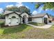 Attractive home featuring a well-manicured lawn and a two-car garage, set against a backdrop of trees at 5092 Abagail Dr, Spring Hill, FL 34608