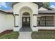 Close-up of the front door showing architectural details and landscaping elements, highlighting the entrance at 5092 Abagail Dr, Spring Hill, FL 34608