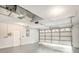 Clean garage with white walls, a white door to the side, and an automated white garage door at 5092 Abagail Dr, Spring Hill, FL 34608