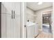 Bright laundry room boasts updated appliances and storage cabinetry near the garage entrance at 5092 Abagail Dr, Spring Hill, FL 34608