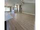 Open-concept living room with vaulted ceilings, natural light, and wood-look flooring that creates a bright and inviting atmosphere at 5092 Abagail Dr, Spring Hill, FL 34608