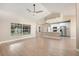 Bright open-plan living room flows into the kitchen, illuminated by a large window at 5092 Abagail Dr, Spring Hill, FL 34608