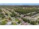 Overhead view of a residential area showcasing well-kept homes surrounded by mature trees and green spaces at 5092 Abagail Dr, Spring Hill, FL 34608