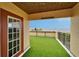 Outdoor balcony features artificial grass, brown trim, and picturesque waterfront views at 6412 Mayra Shores Ln, Apollo Beach, FL 33572