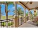 Open balcony showcasing palm trees, the horizon and seating overlooking the outdoor area at 6412 Mayra Shores Ln, Apollo Beach, FL 33572