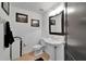 Cozy powder room featuring a pedestal sink, toilet, and stylish decor at 6412 Mayra Shores Ln, Apollo Beach, FL 33572