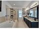 This bathroom offers a walk-in shower, and vanity with granite counters at 6412 Mayra Shores Ln, Apollo Beach, FL 33572