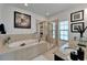 Relax in this bright bathroom with soaking tub, walk-in shower, and granite counters at 6412 Mayra Shores Ln, Apollo Beach, FL 33572