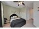 Well decorated bedroom with carpet, ceiling fan, accent wall, and visible doorway at 6412 Mayra Shores Ln, Apollo Beach, FL 33572