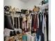 Walk-in closet with shelves and rods filled with clothing and personal items at 6412 Mayra Shores Ln, Apollo Beach, FL 33572